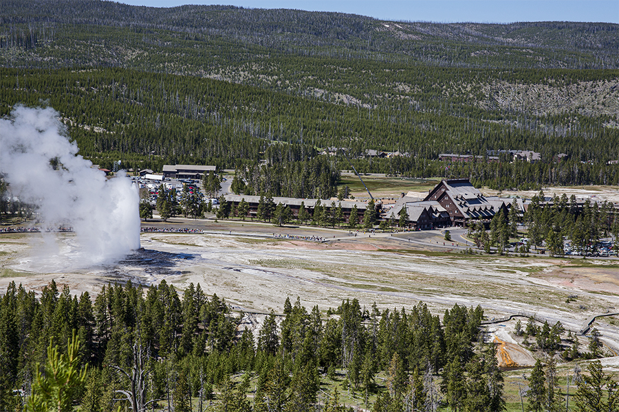 Old Faithful erupting image taken from Observation Point above the Upper Geyser Basin.