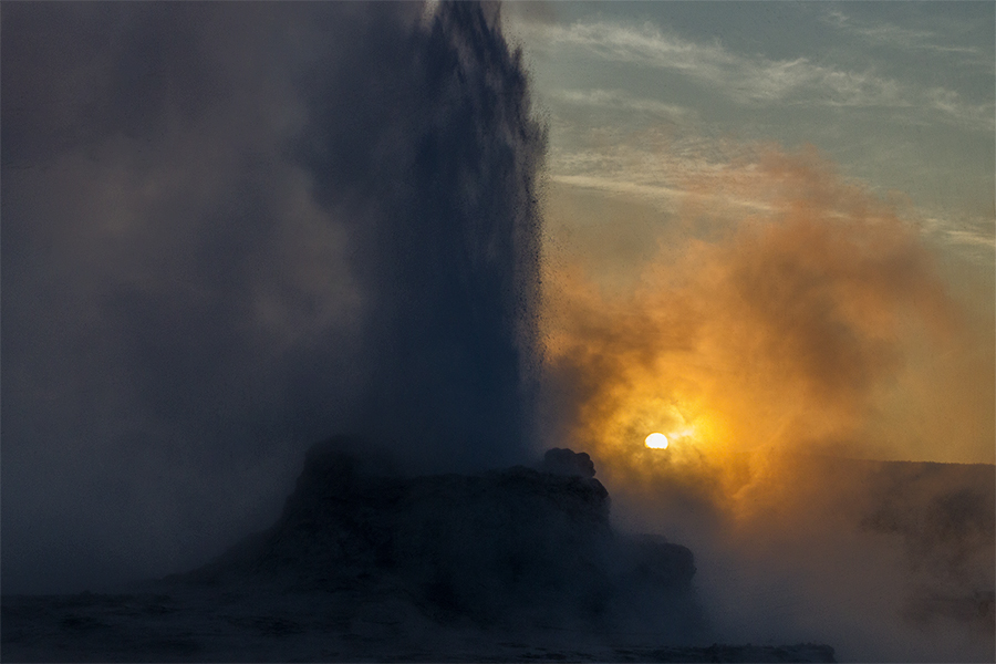 Sunrising behind an eruption of Castle Geyser