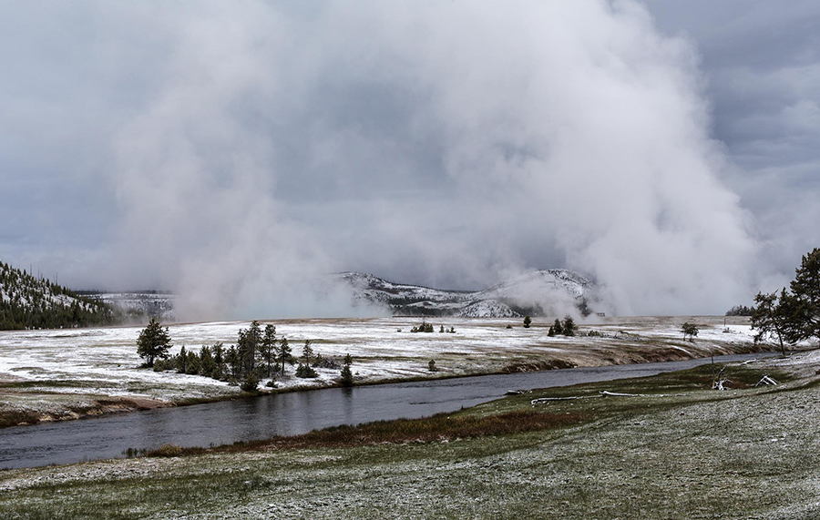 Midway Geyser Basin with mist coming off Grand Prismatic Spring and Excelsior Geyser.